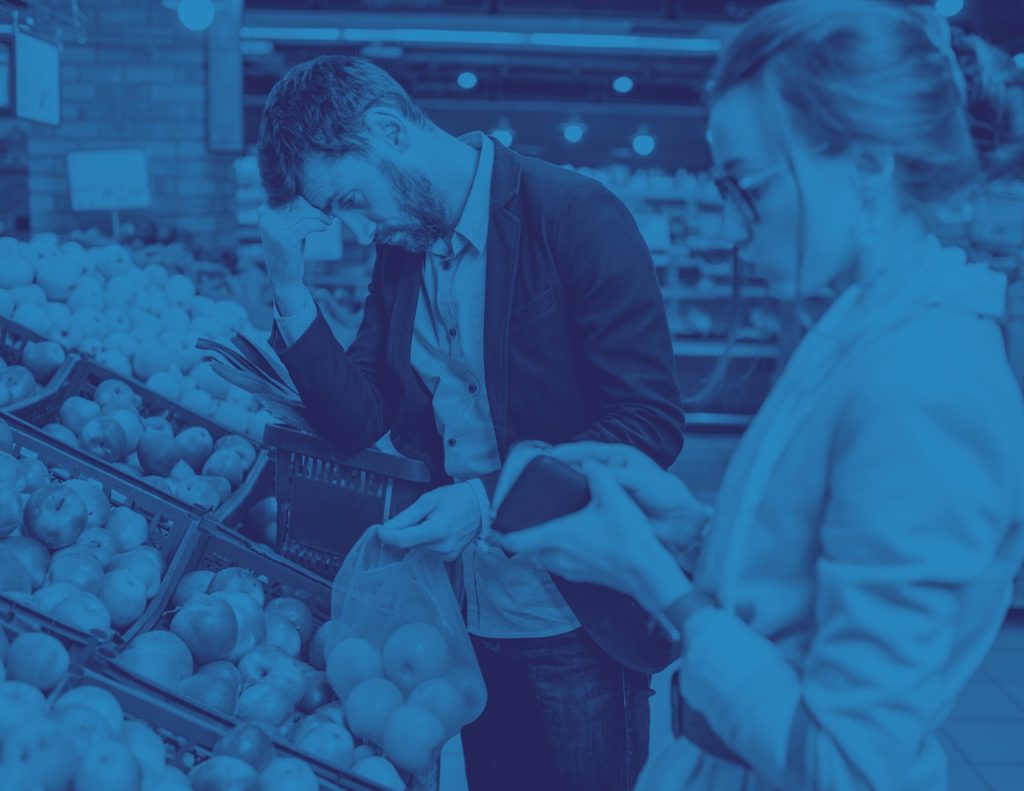 Illustration for the cost of living: two shoppers choosing produce in a grocery store